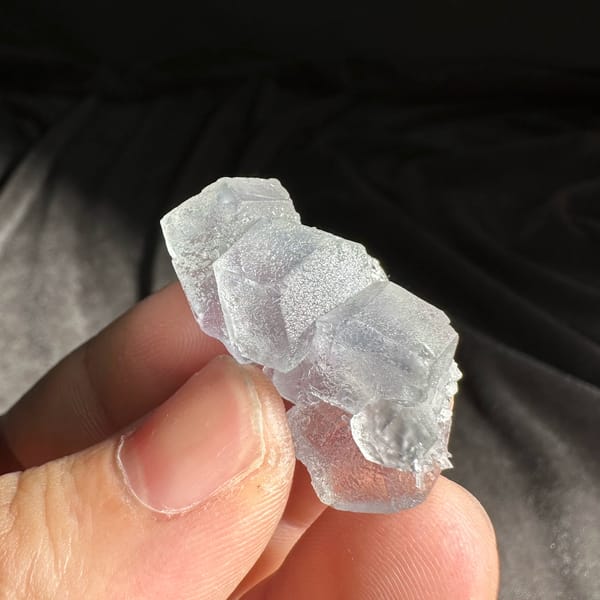 Pale blue-green fluorite cube group from Fujian, China, close-up of the crystal faces