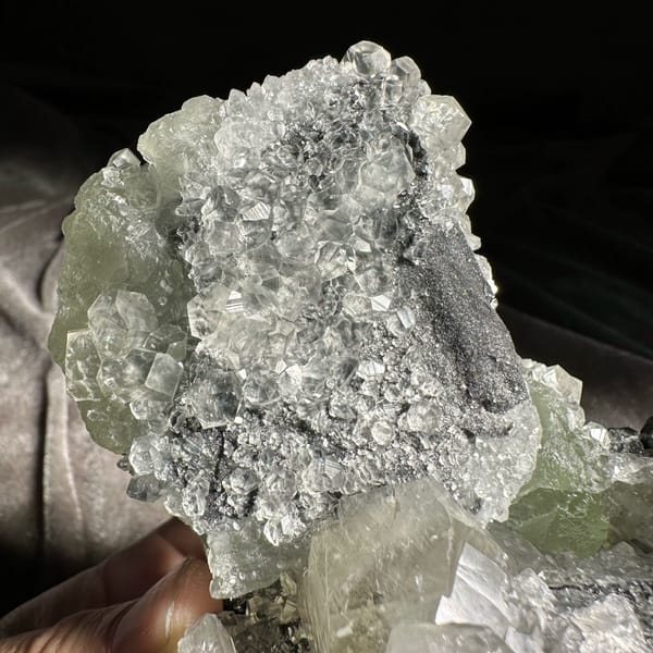 Mountain-shaped pale green fluorite cluster on dark quartz from Fujian, China, top view