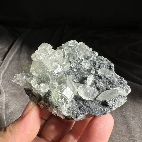 Clear star-patterned calcite with green fluorite on dark druse from Fujian, China