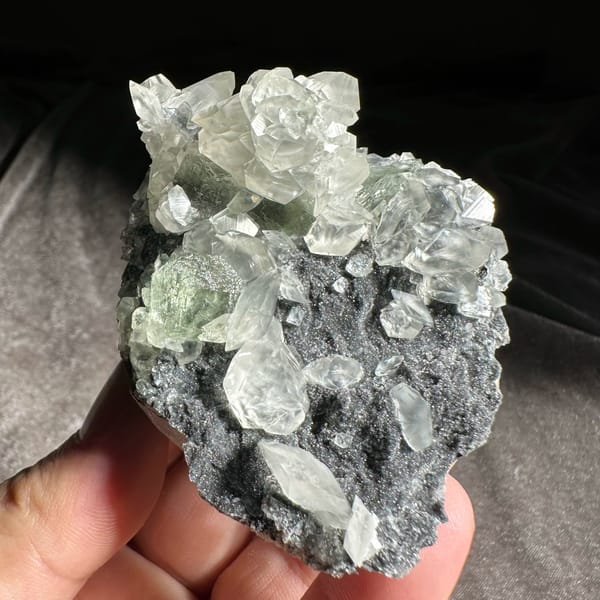 Clear star-patterned calcite with green fluorite on dark druse from Fujian, China, reverse side