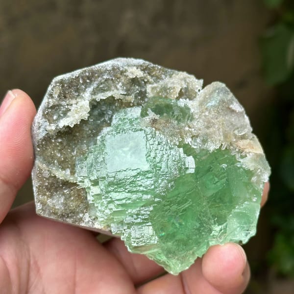 Cross-shaped stack of transparent green fluorite cubes from Fujian, China, reverse side