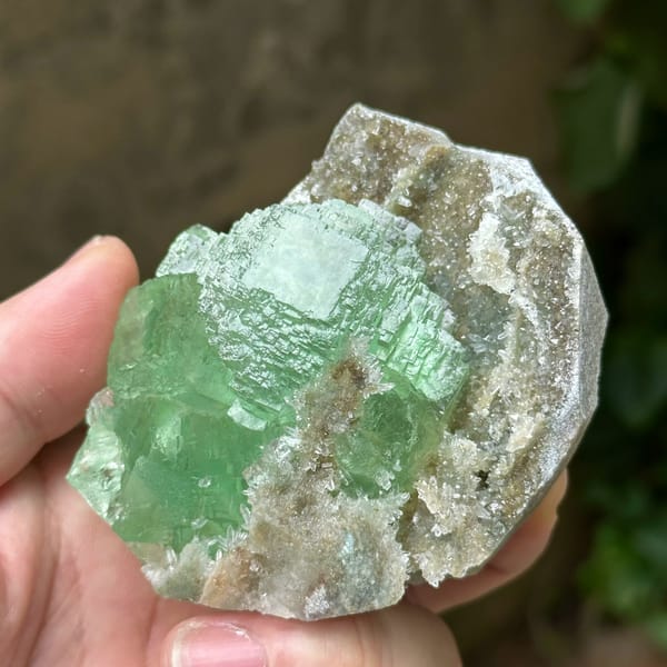 Cross-shaped stack of transparent green fluorite cubes from Fujian, China, top view