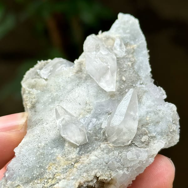 Double-terminated calcite on pale fluorite and quartz from Hunan, China, close-up of the crystal faces