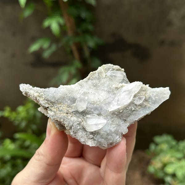 Double-terminated calcite on pale fluorite and quartz from Hunan, China, detail of the matrix contact