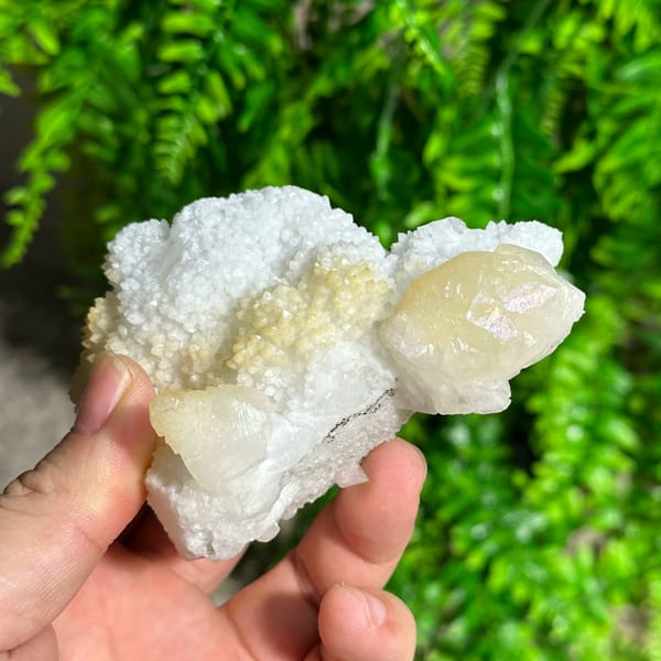 Iridescent calcite spire on sparkling white quartz from Fujian, China, close-up of the crystal faces