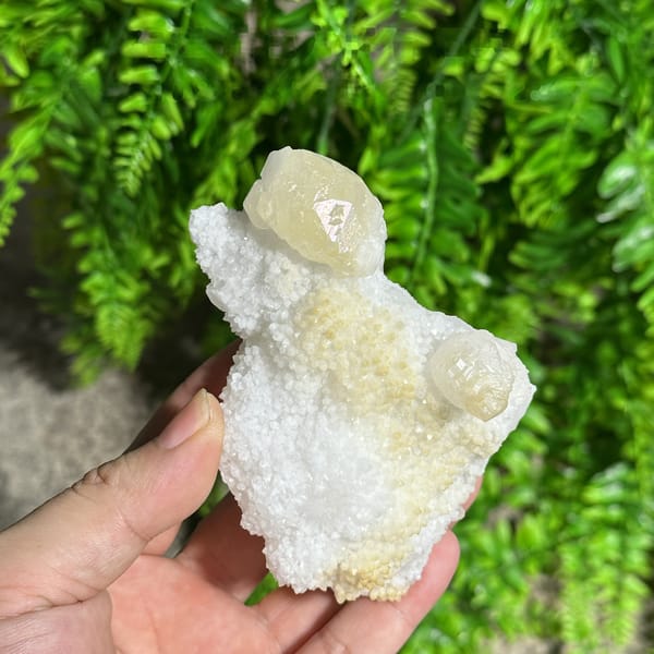 Iridescent calcite spire on sparkling white quartz from Fujian, China, detail of the matrix contact