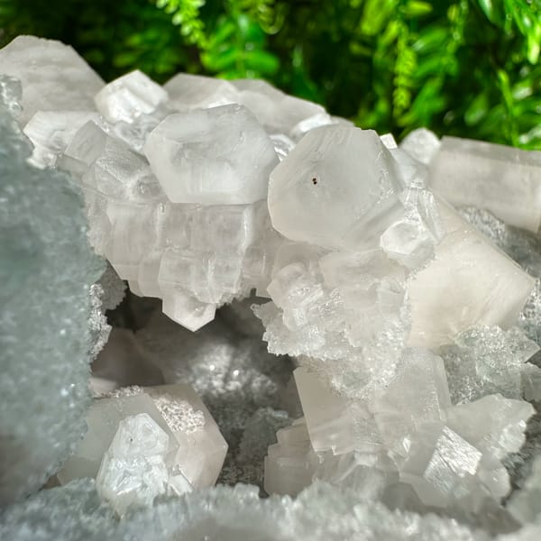 Frosted white prismatic calcite on grey quartz druse from Fujian, China, top view