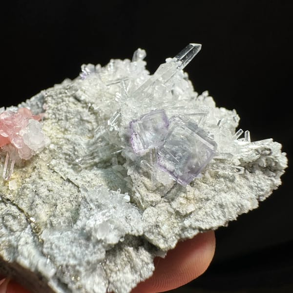 Pink rhodochrosite and purple fluorite with quartz needles from Wuzhou, Guangxi, China, top view
