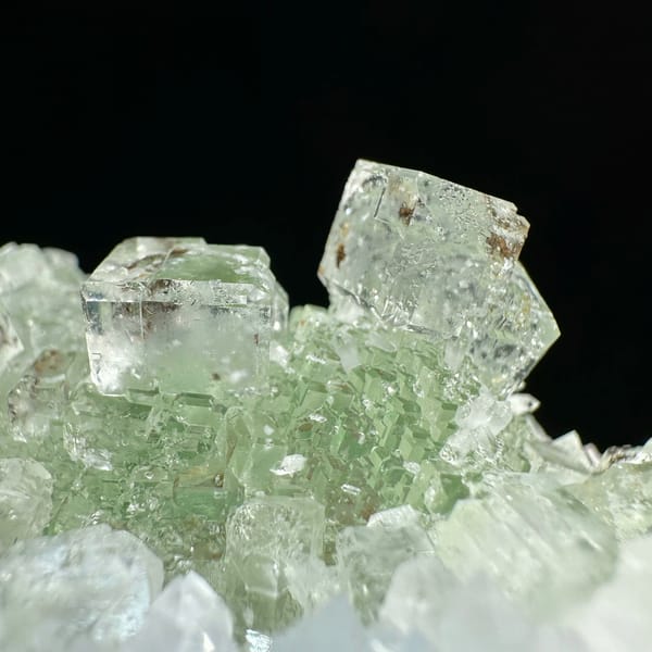 Stepped glassy green fluorite with inclusions on white quartz from Guangdong, China, second angle