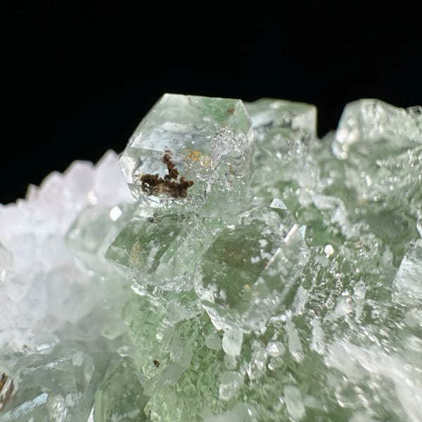 Stepped glassy green fluorite with inclusions on white quartz from Guangdong, China, reverse side