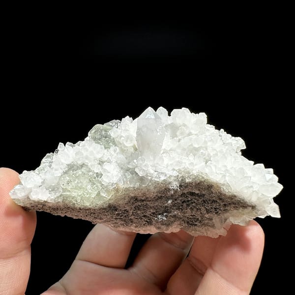 White quartz druse plate with pale green fluorite from Guangdong, China, detail of the matrix contact