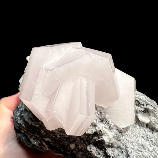 Pink-cored sandwich calcite crystal on dark matrix from Fujian, China, close-up of the crystal faces