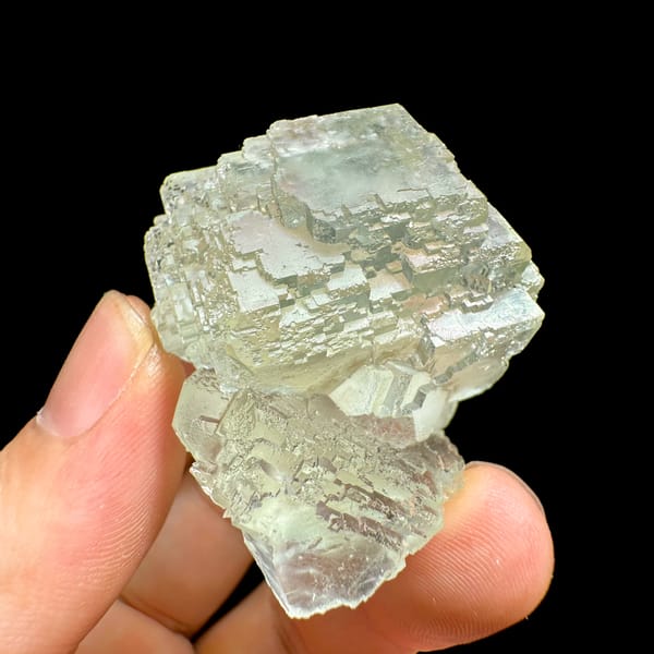 Glass-clear pale green fluorite cube from Guangdong, China, close-up of the crystal faces