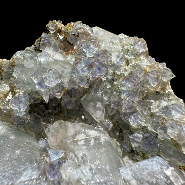 Pale blue-cored fluorite octahedra with white calcite from Fujian, China, close-up of the crystal faces