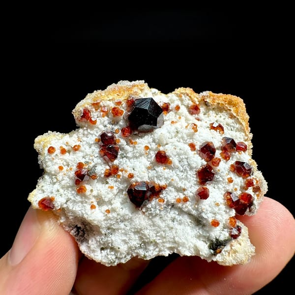 Large dark-red garnets with hyalite opal on white feldspar from Yunxiao, Fujian, China