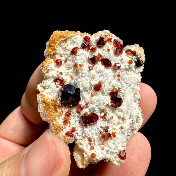 Large dark-red garnets with hyalite opal on white feldspar from Yunxiao, Fujian, China, reverse side
