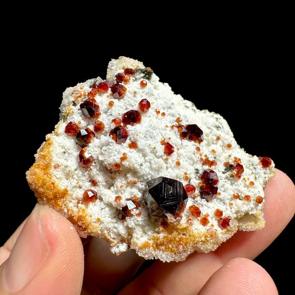 Large dark-red garnets with hyalite opal on white feldspar from Yunxiao, Fujian, China, top view