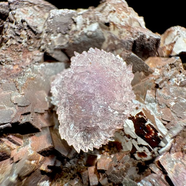 Purple creedite ball on iron-stained fluorite cubes from Guizhou, China, close-up of the crystal faces
