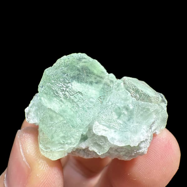 Two glassy mint-green fluorite cubes on quartz from Xianghualing, Hunan, China, second angle
