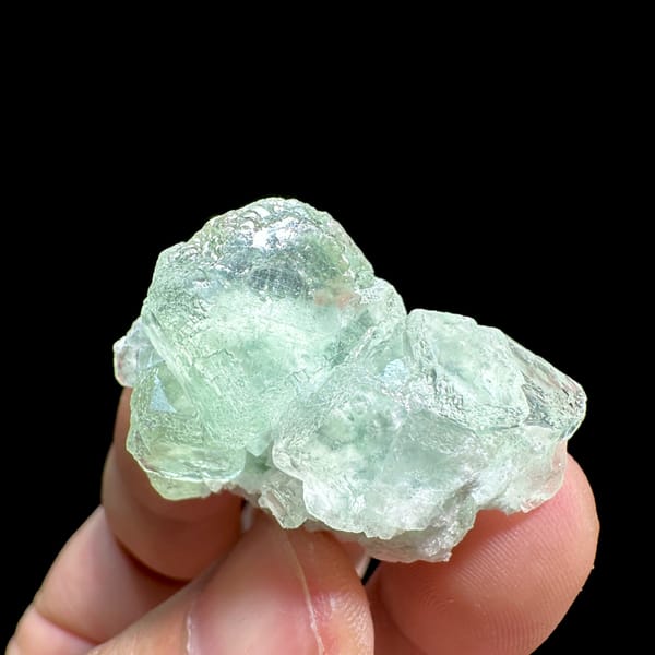 Two glassy mint-green fluorite cubes on quartz from Xianghualing, Hunan, China, reverse side