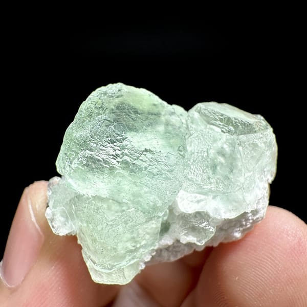 Two glassy mint-green fluorite cubes on quartz from Xianghualing, Hunan, China, top view