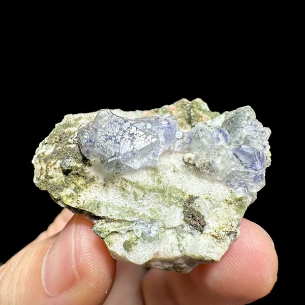 Pale blue fluorite octahedra on white feldspar from Yunxiao, Fujian, China, close-up of the crystal faces