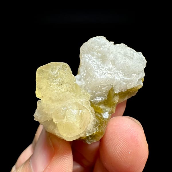 Golden-yellow calcite with white dolomite and siderite from Guizhou, China, held in hand