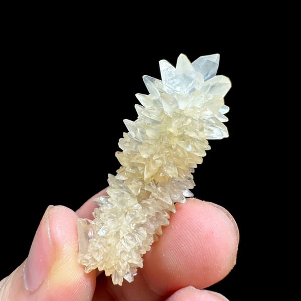 Slender pillar of stacked white calcite crystals from Yunnan, China, reverse side
