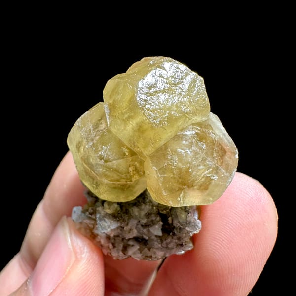 Glassy yellow calcite crystals with dolomite and siderite from Guizhou, China, close-up of the crystal faces