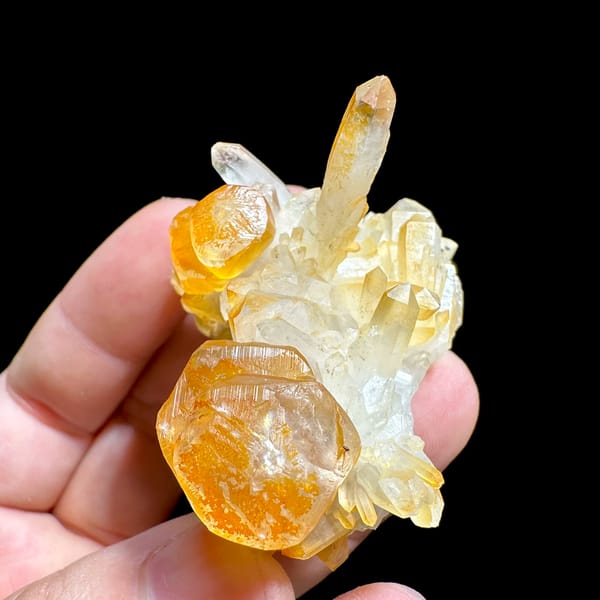 Orange-skinned calcite blades with clear quartz spire from Fujian, China, top view