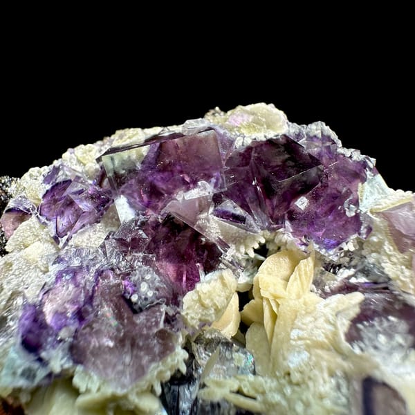 Glassy purple phantom fluorite cubes on cream siderite from Inner Mongolia, China, top view