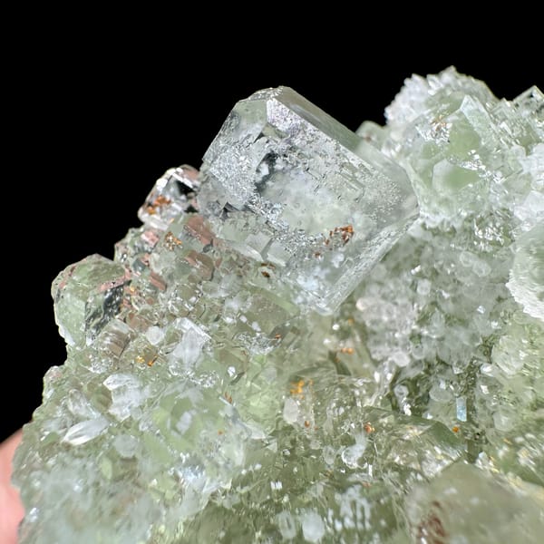Pale green fluorite cubes with inclusions from Guangdong, China, close-up of the crystal faces