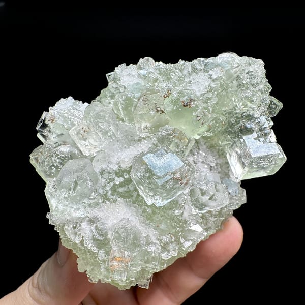 Pale green fluorite cubes with inclusions from Guangdong, China, detail of the matrix contact