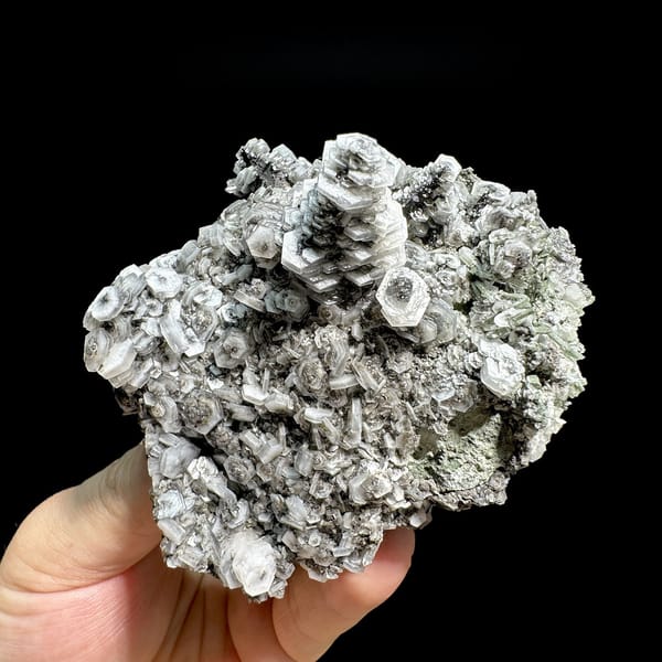 Hexagonal tower calcite crystals on grey quartz from Fujian, China, detail of the matrix contact