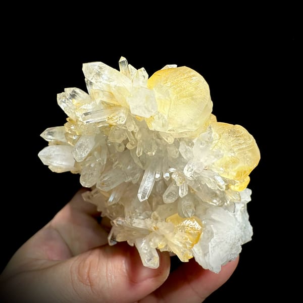 Golden-skinned calcite crystals with clear quartz spray from Fujian, China, close-up of the crystal faces