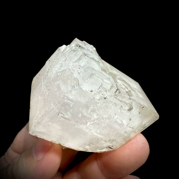 Large colourless calcite rhomb with pyrite from Fujian, China, close-up of the crystal faces