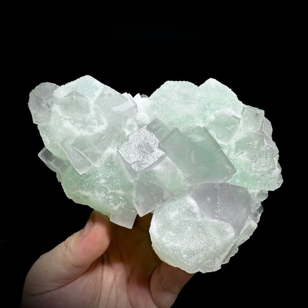 Twinned purple and green sugar fluorite cubes from Jiangxi, China, detail of the matrix contact