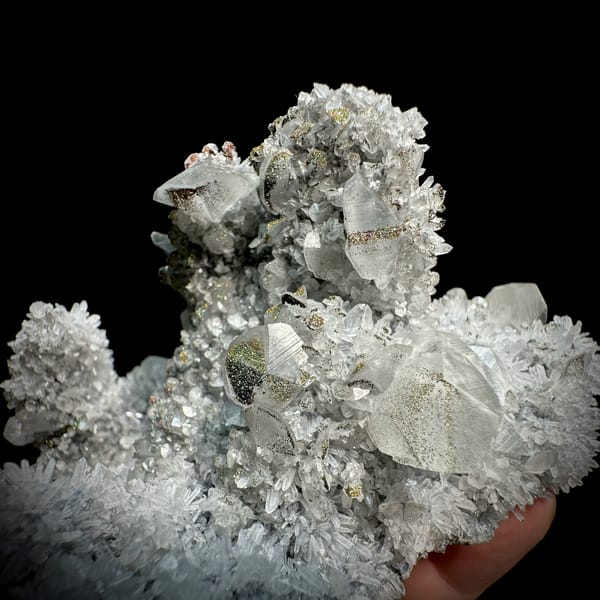 Star calcite crystals on grey quartz needles with pyrite from Fujian, China, close-up of the crystal faces
