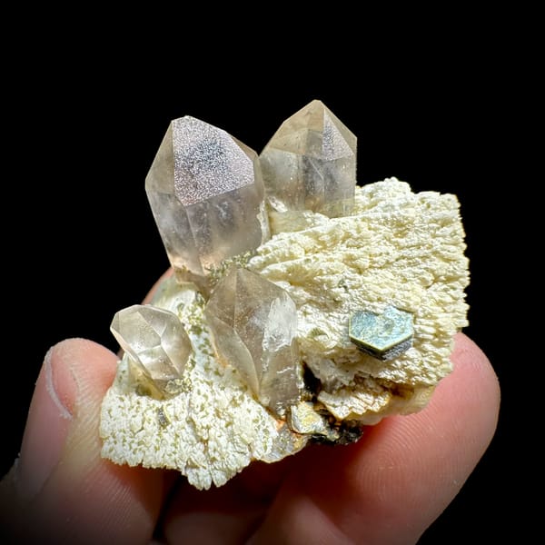 Pale smoky quartz points on cream feldspar with mica from Yunxiao, Fujian, China, second angle