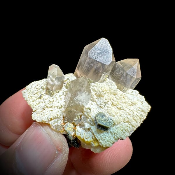 Pale smoky quartz points on cream feldspar with mica from Yunxiao, Fujian, China, reverse side