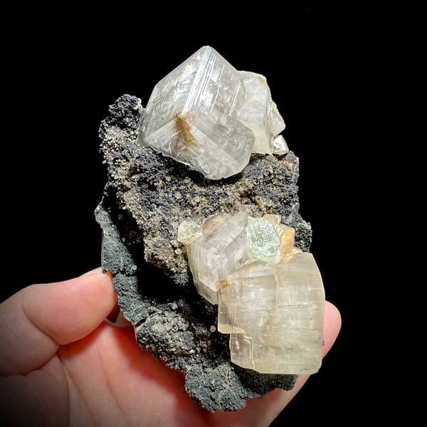 Star calcite crystals enclosing green fluorite on dark matrix from Fujian, China, reverse side