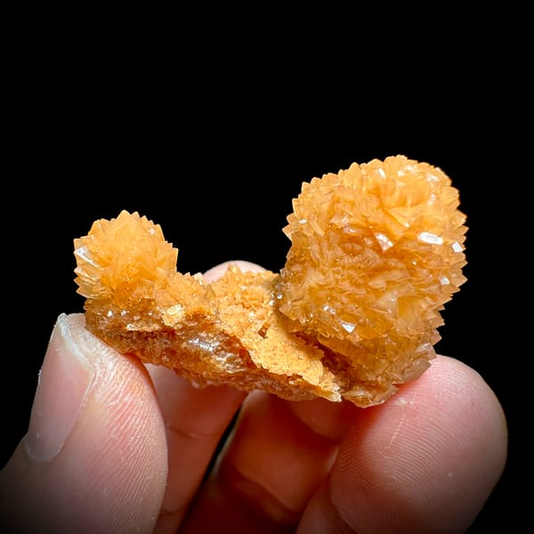 Two peach-orange botryoidal calcite balls from Yunnan, China, second angle