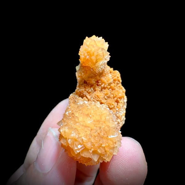 Two peach-orange botryoidal calcite balls from Yunnan, China, reverse side