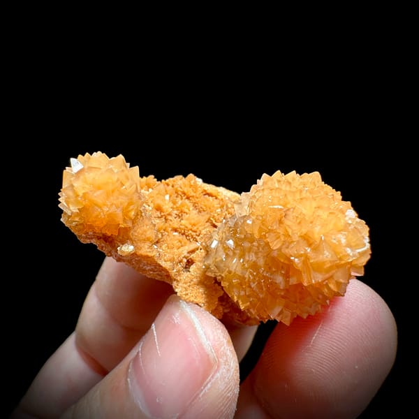 Two peach-orange botryoidal calcite balls from Yunnan, China, top view