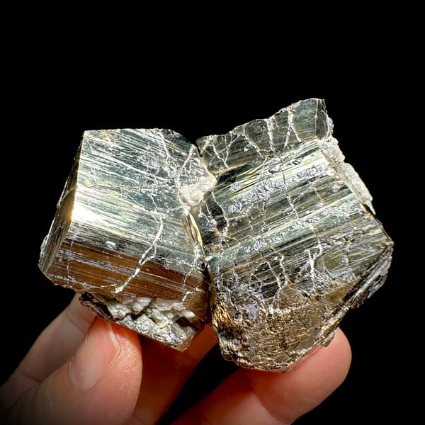 Two interlocking striated brass-gold pyrite crystals from Hunan, China, second angle