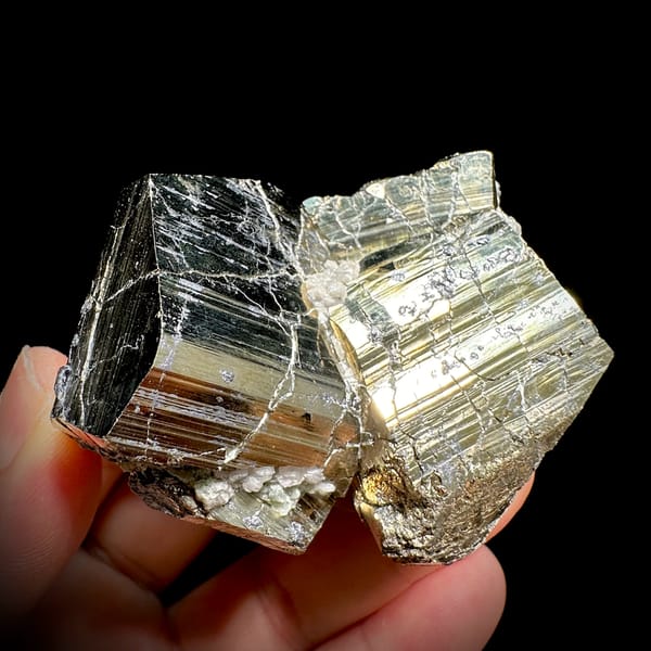 Two interlocking striated brass-gold pyrite crystals from Hunan, China, reverse side