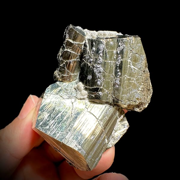 Two interlocking striated brass-gold pyrite crystals from Hunan, China, top view