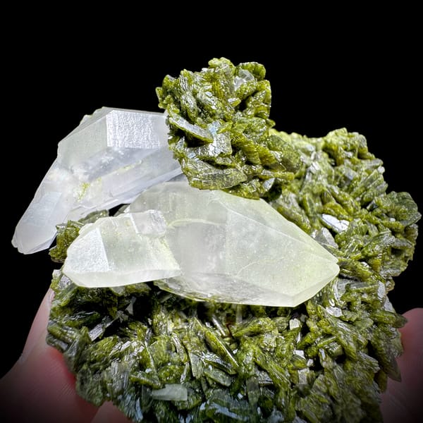 Clear double-terminated quartz nested in green epidote from Sichuan, China, close-up of the crystal faces
