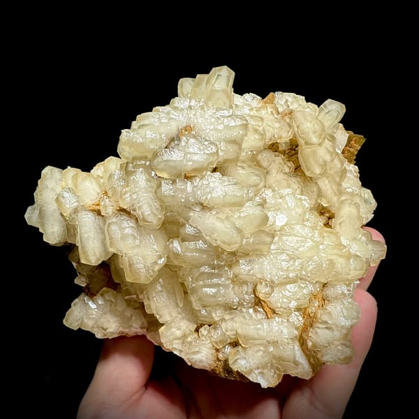 Mound of hammer-headed cream calcite crystals from Guizhou, China, second angle