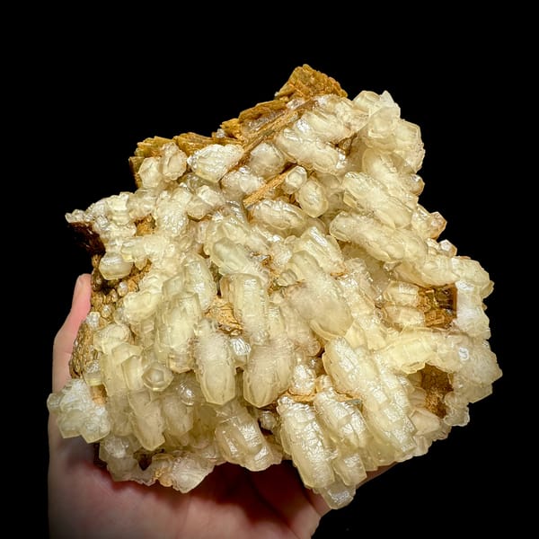 Hammer-headed calcite crystals over golden siderite from Guizhou, China, reverse side